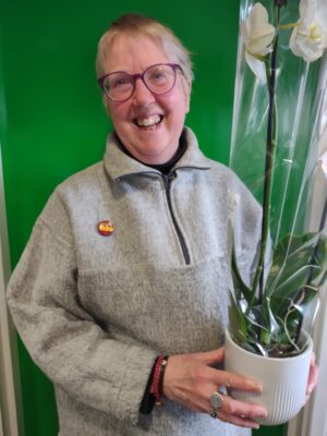 Yvonne is a volunteer letter writer for The Prison Phoenix Trust. She is pictured here holding a gift giving to her after her 20 year service to the charity.